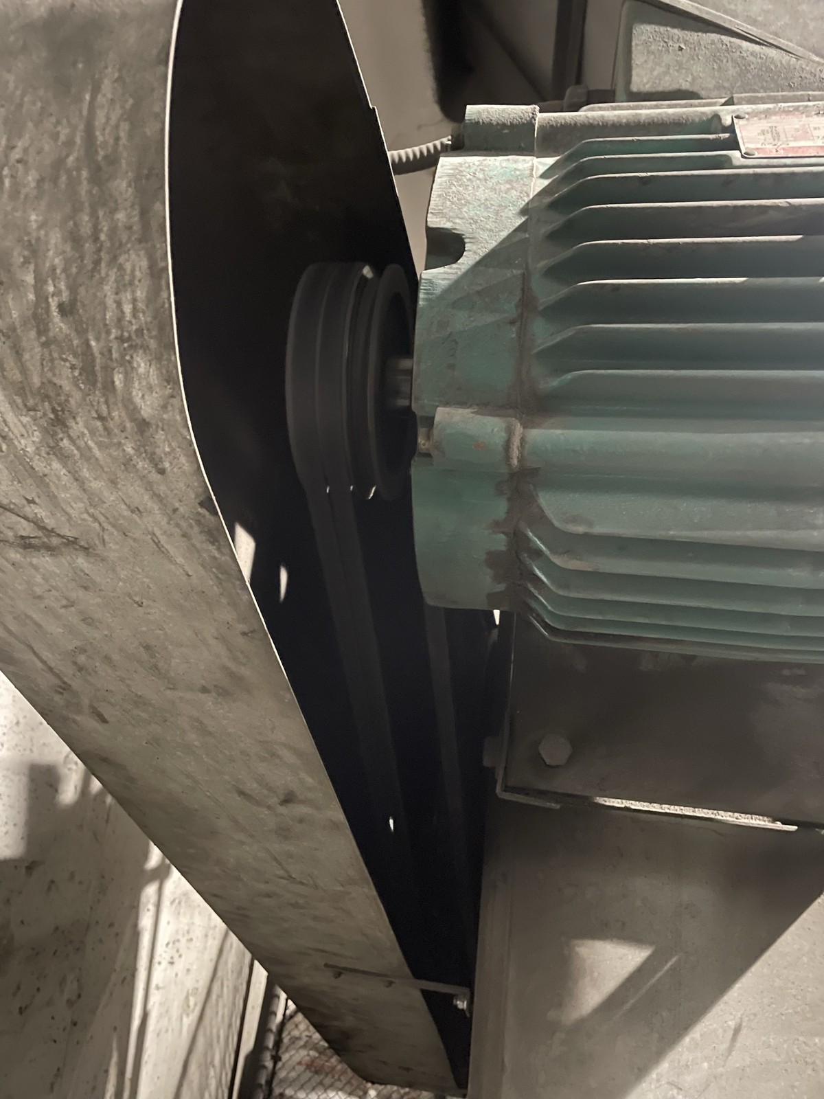 The pulley and V-belts on the 30 HP fan motor, with the fan shroud at the left