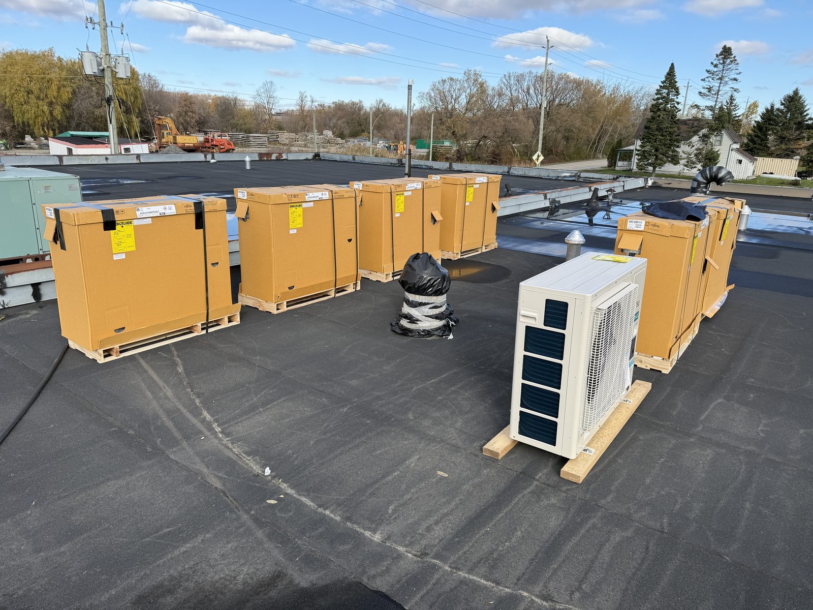 Crated heat pump units delivered to a flat roof
