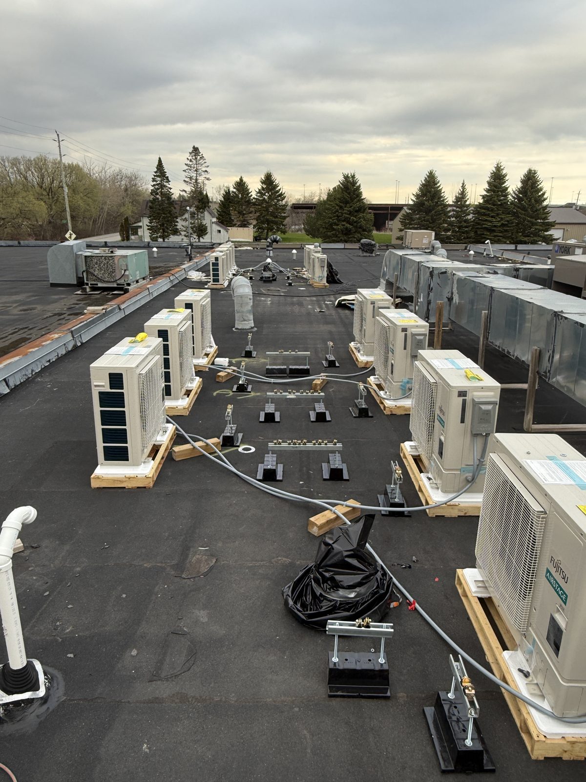 Heat pump units set on their stands on a flat roof