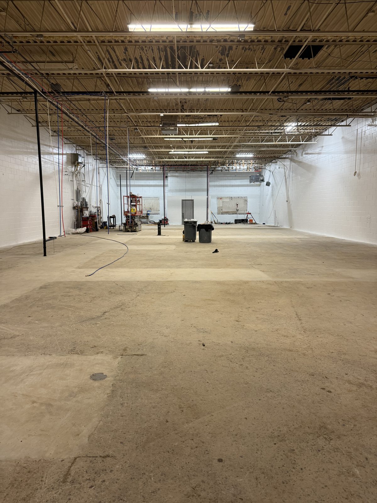 The warehouse floor with the trenches filled and the concrete slab poured back