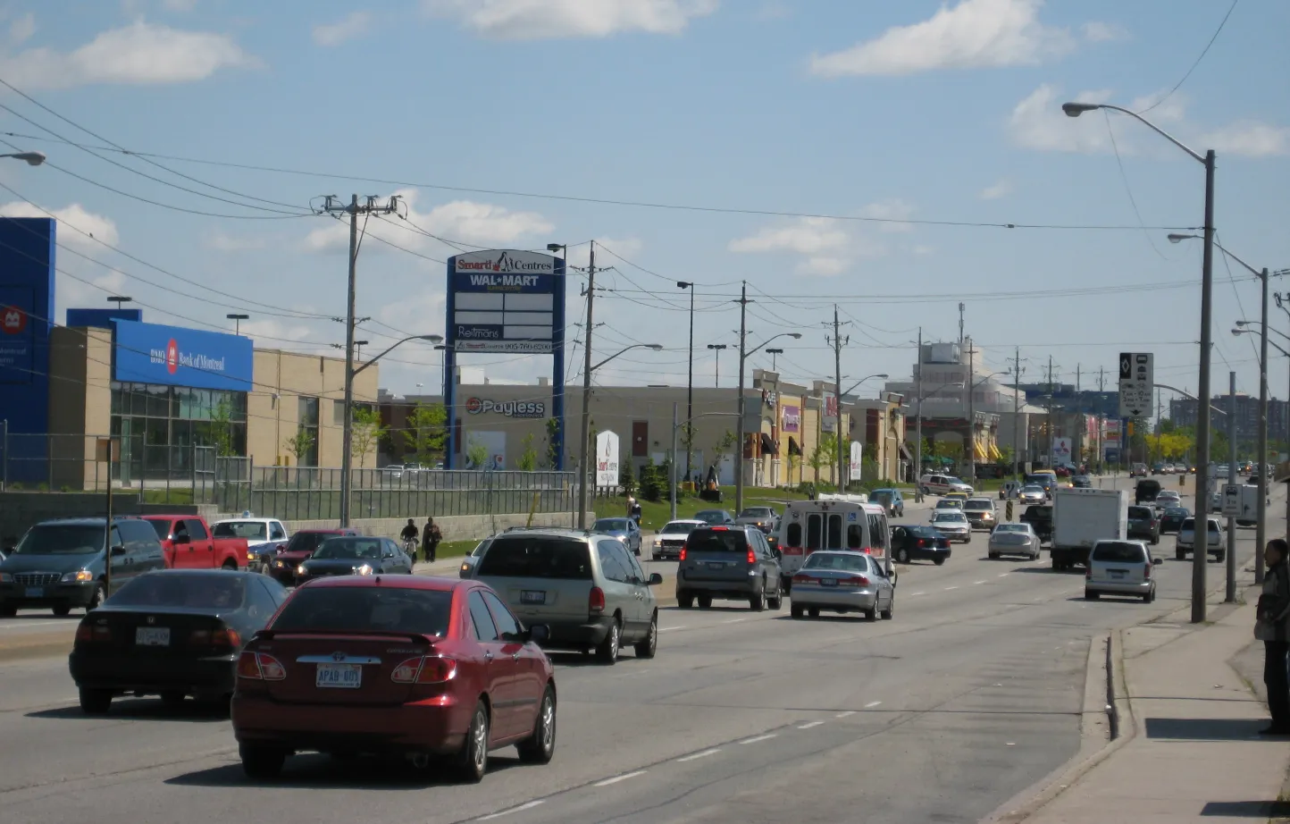 Busy street view of the Golden Mile shopping district in Scarborough, Toronto with traffic and retail stores. Backflow prevention in Scarborough is a critical, but understated regulation.